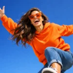 A young woman with spread in the air arms is enjoying the life.A concept for Life,Lifestyle and Health