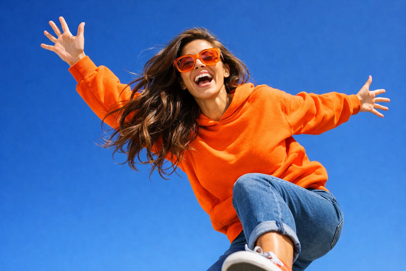 A young woman with spread in the air arms is enjoying the life.A concept for Life,Lifestyle and Health